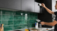 Black, Bold Cabinets and Dramatic Green Tiles Refresh This 2000s Kitchen